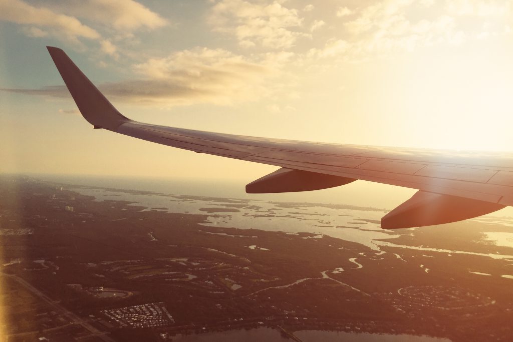 Aeroplane wing with mica insulation over sunset scene of city