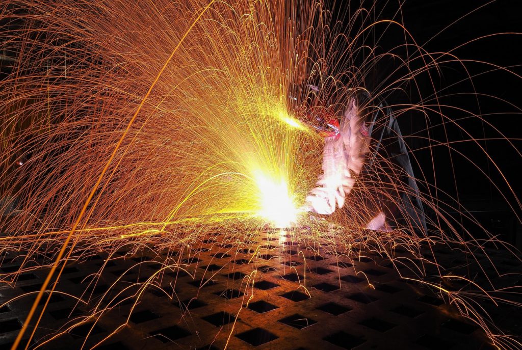 Person welding using high temperature insulation