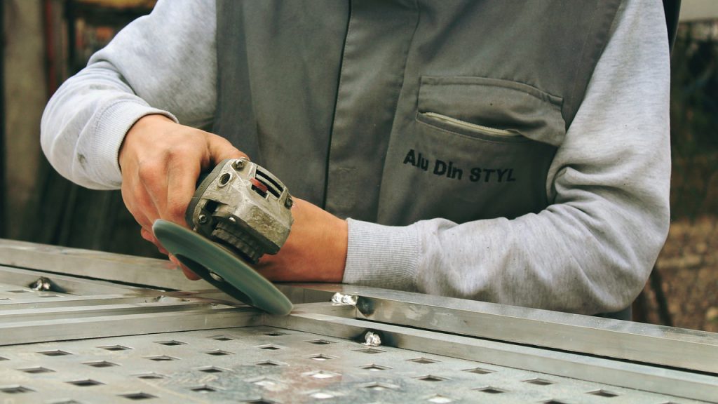 person using an angle grinder for a blog by elmelin on mica and electricity